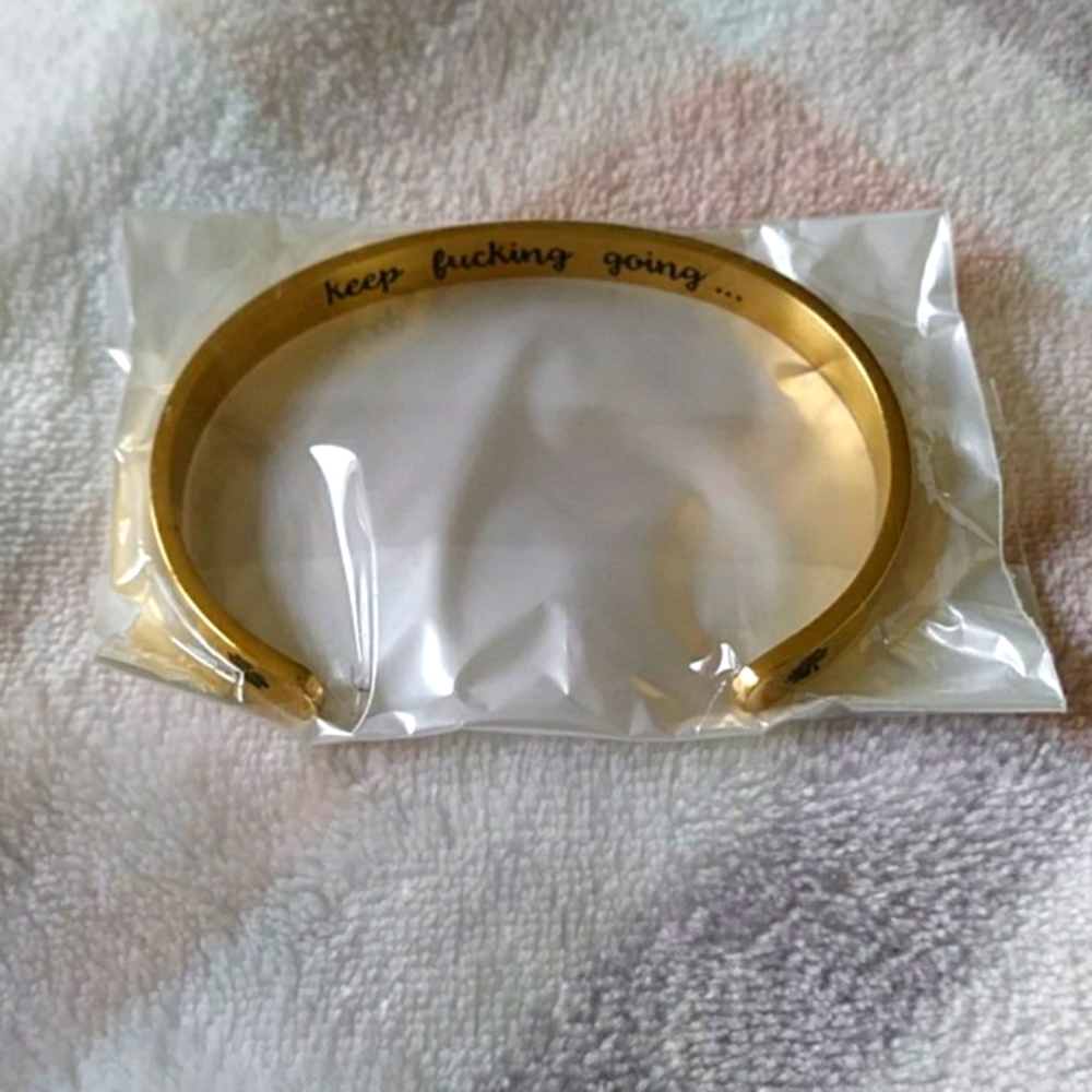 Gold colored bracelet with underside message